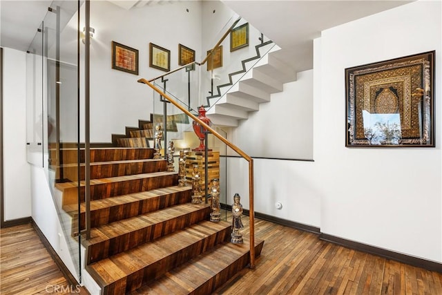 stairs featuring baseboards and hardwood / wood-style floors