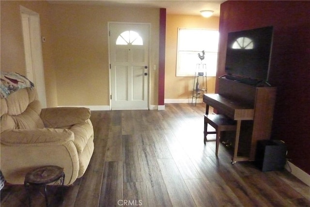 foyer entrance featuring wood finished floors and baseboards