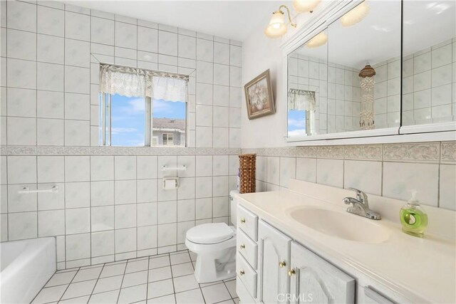 full bath featuring tile patterned flooring, toilet, vanity, a bathing tub, and tile walls