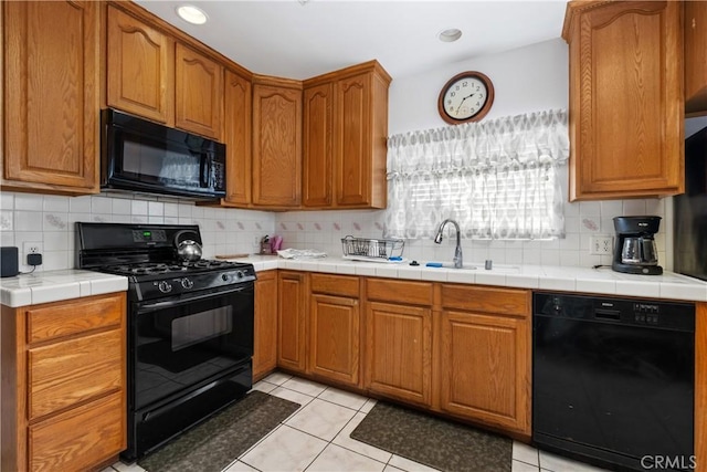 kitchen with decorative backsplash, black appliances, light tile patterned flooring, and brown cabinetry