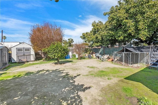 view of yard with an outdoor structure and fence