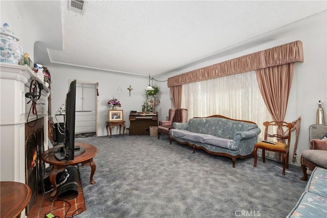 carpeted living area with visible vents and a textured ceiling