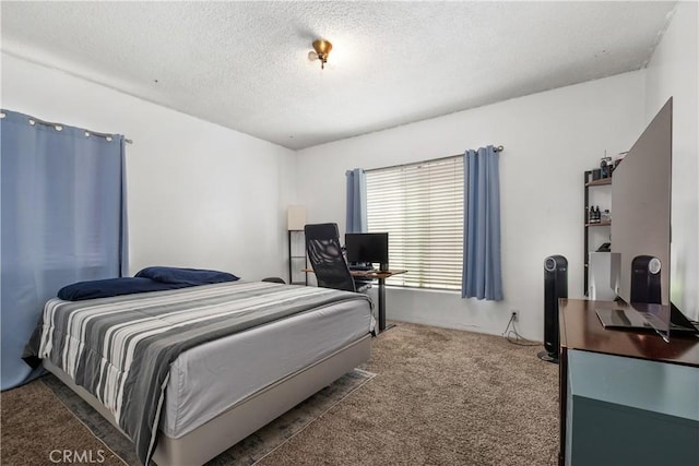 bedroom featuring a textured ceiling and carpet