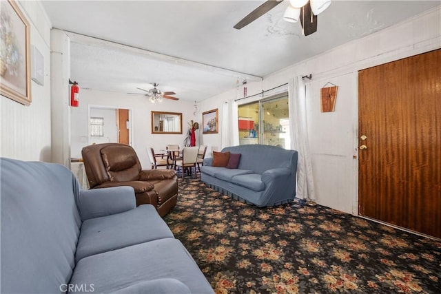 living area featuring carpet flooring and ceiling fan