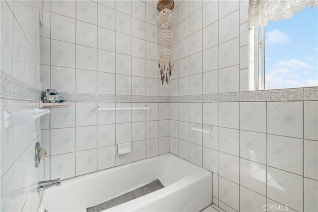 full bath with an inviting chandelier