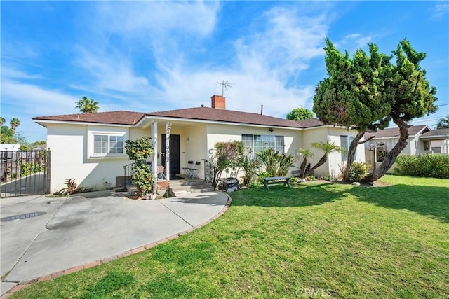 single story home with stucco siding, a chimney, a front lawn, and fence