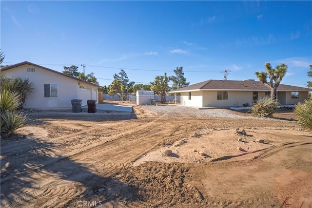 view of yard featuring a garage and fence