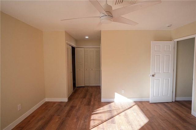 unfurnished bedroom featuring wood finished floors, a ceiling fan, and baseboards