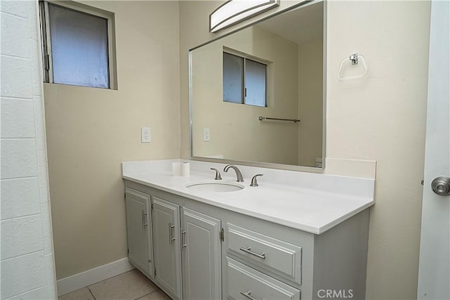 bathroom with tile patterned flooring, vanity, and baseboards