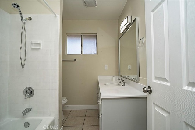 bathroom featuring baseboards, toilet,  shower combination, tile patterned flooring, and vanity