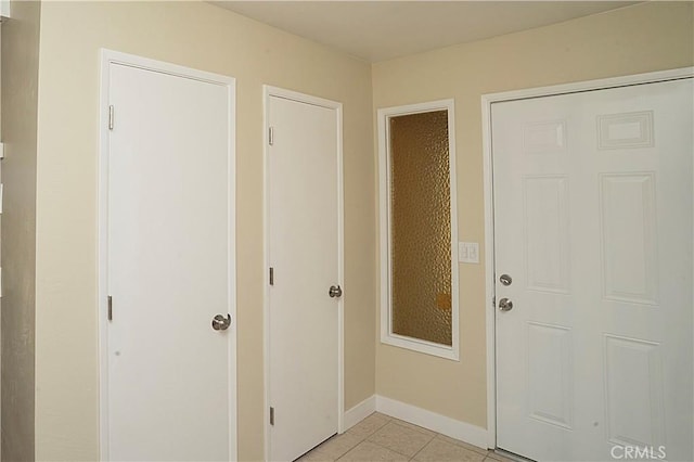 entrance foyer featuring light tile patterned floors and baseboards