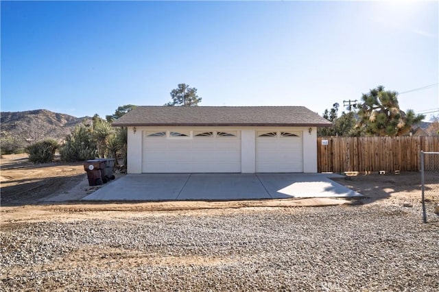 detached garage with fence and a mountain view