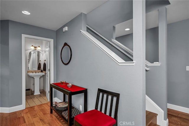 hall with stairway, recessed lighting, wood finished floors, and baseboards