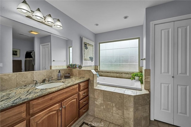 full bathroom with a bath, tile patterned flooring, a closet, and vanity