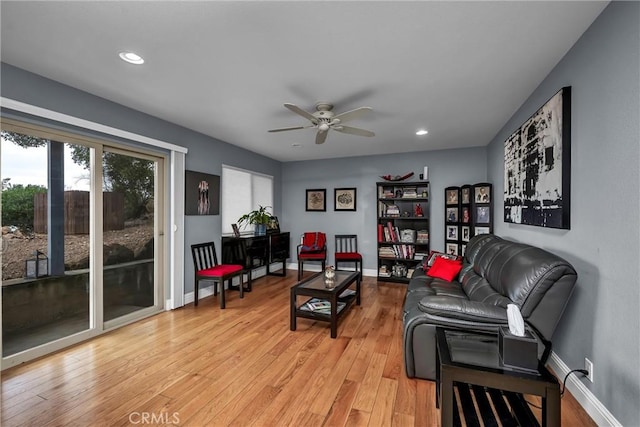 living area with light wood-type flooring, ceiling fan, baseboards, and recessed lighting