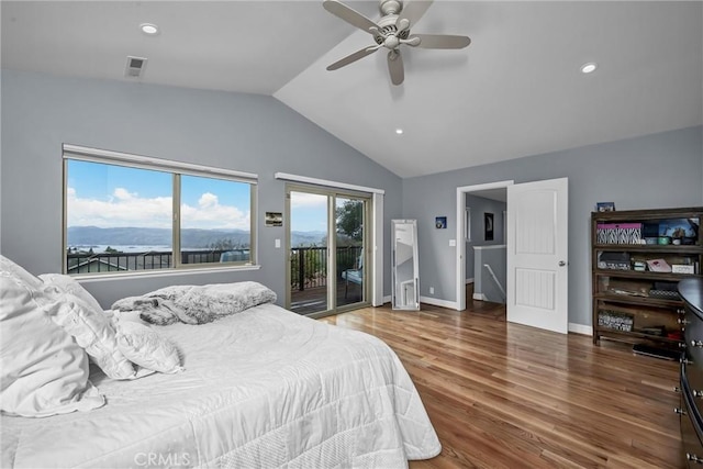 bedroom with baseboards, visible vents, wood finished floors, access to outside, and vaulted ceiling