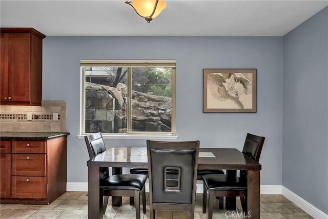 dining area featuring baseboards