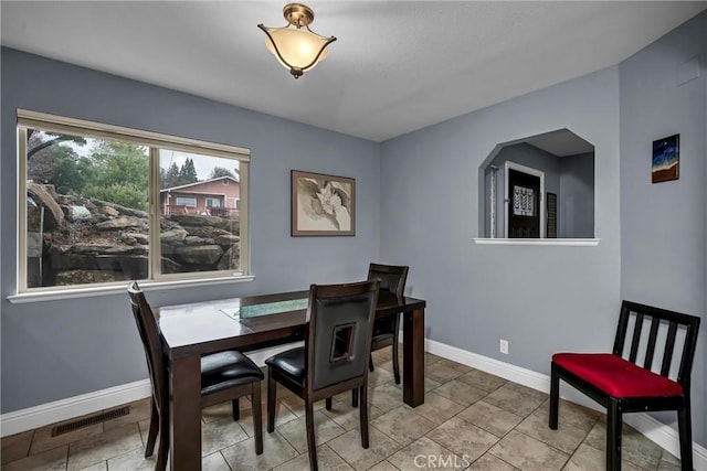 dining room featuring visible vents and baseboards