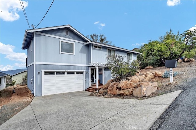 traditional-style house featuring a garage and driveway