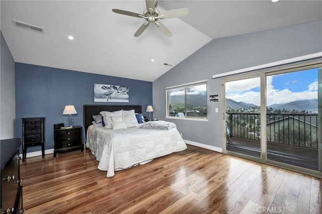 bedroom with access to exterior, lofted ceiling, visible vents, and wood finished floors