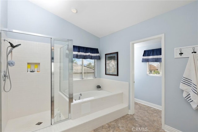 full bath with lofted ceiling, a stall shower, a garden tub, and baseboards