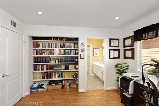 office featuring light wood-style flooring, visible vents, baseboards, and recessed lighting