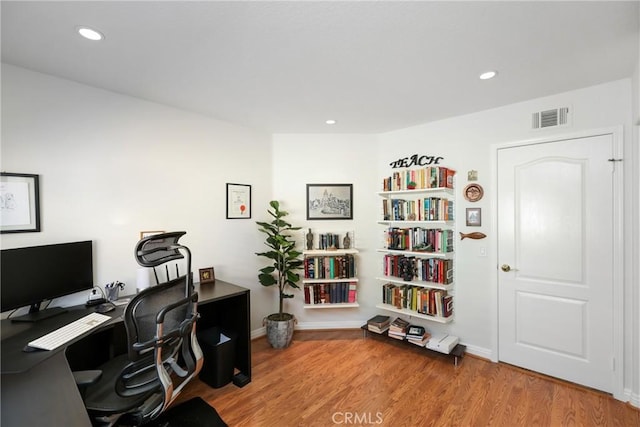 office space featuring baseboards, wood finished floors, visible vents, and recessed lighting