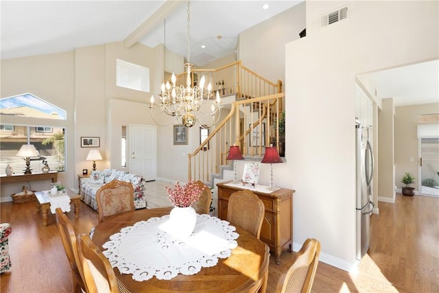 dining room with high vaulted ceiling, visible vents, stairway, beamed ceiling, and an inviting chandelier