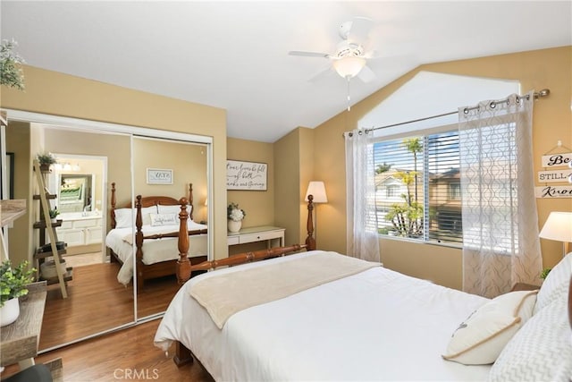 bedroom featuring lofted ceiling, a closet, wood finished floors, and a ceiling fan