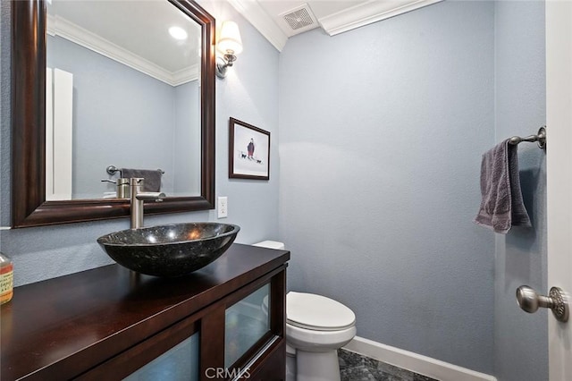 half bath with crown molding, visible vents, toilet, vanity, and baseboards