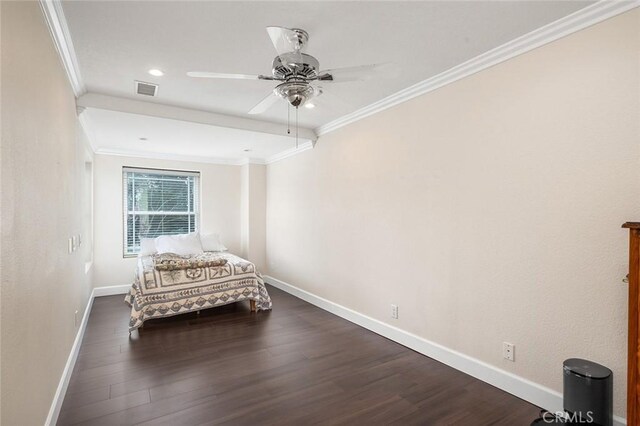 unfurnished bedroom featuring ornamental molding, dark wood-type flooring, visible vents, and baseboards