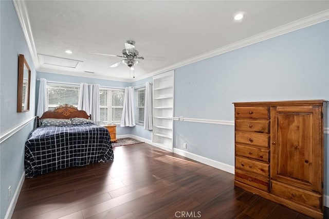 unfurnished bedroom with attic access, ornamental molding, baseboards, and wood finished floors