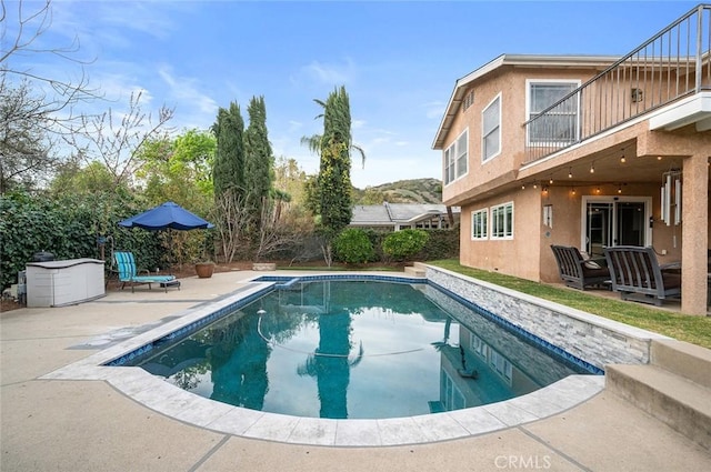 outdoor pool featuring a patio