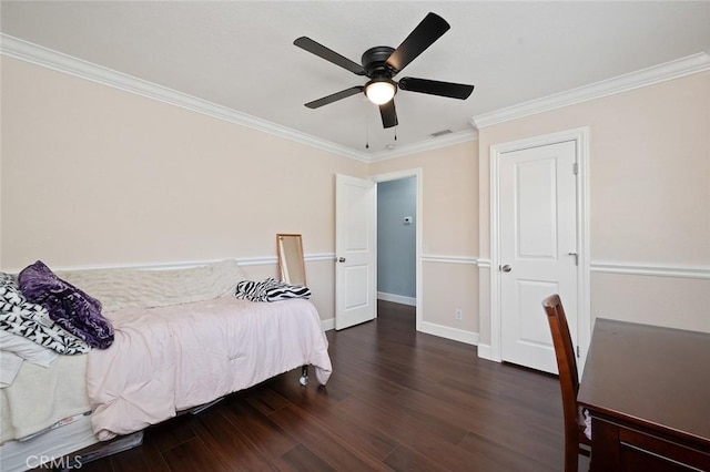 bedroom featuring crown molding, visible vents, ceiling fan, wood finished floors, and baseboards