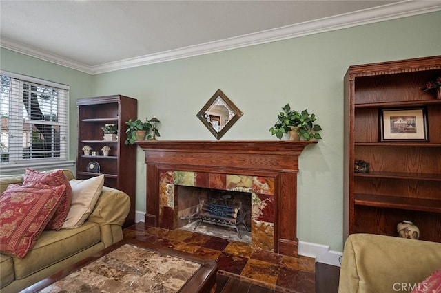 living room with baseboards, a high end fireplace, and crown molding