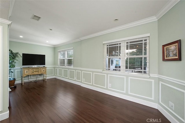 unfurnished living room featuring visible vents, wood finished floors, crown molding, a decorative wall, and recessed lighting