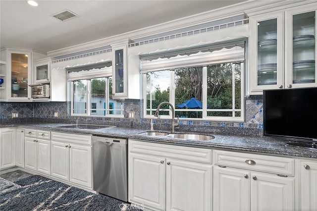 kitchen with visible vents, decorative backsplash, white cabinets, a sink, and dishwasher