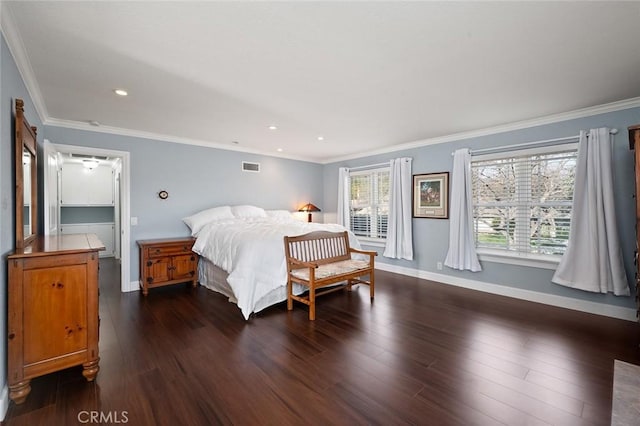 bedroom featuring ornamental molding, dark wood finished floors, visible vents, and baseboards