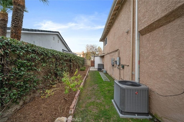 view of yard featuring fence and cooling unit