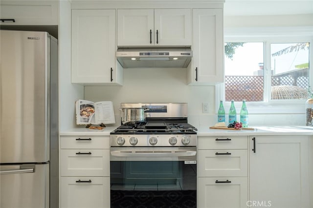 kitchen with light countertops, appliances with stainless steel finishes, white cabinetry, and under cabinet range hood