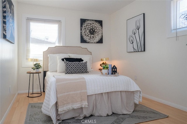 bedroom featuring baseboards and wood finished floors