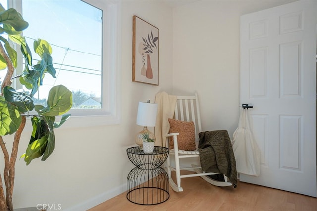 sitting room with wood finished floors and baseboards