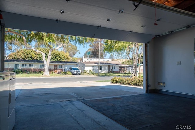 exterior space featuring driveway and a residential view