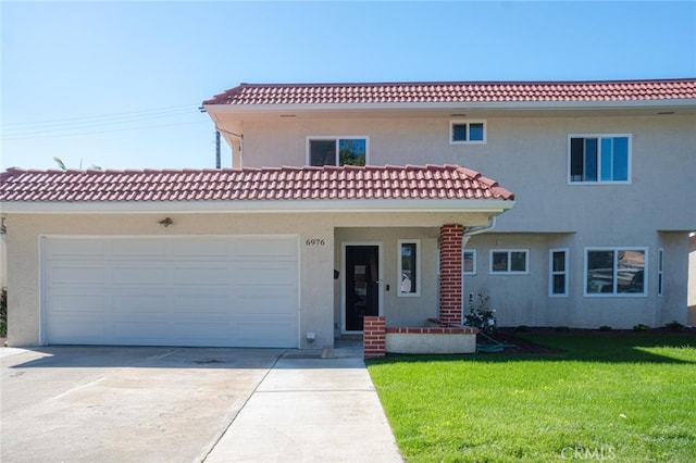 view of front of home featuring a tile roof, stucco siding, a garage, driveway, and a front lawn