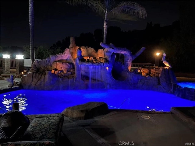 pool at twilight featuring an outdoor pool