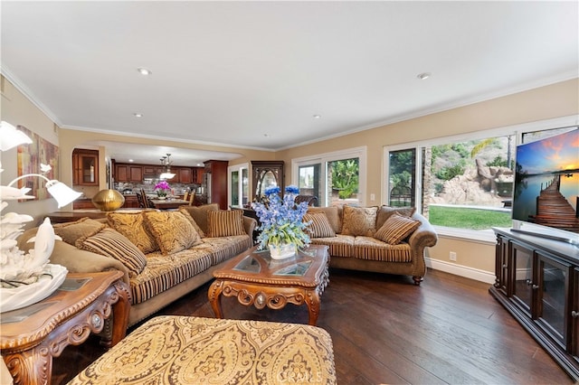 living area with hardwood / wood-style flooring, baseboards, and ornamental molding