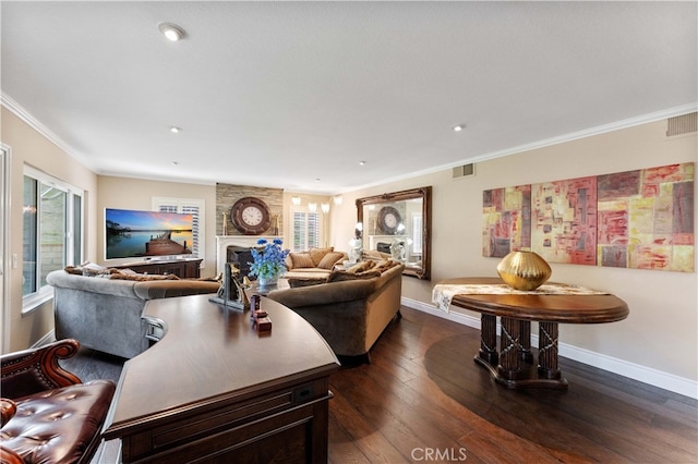 living area with visible vents, ornamental molding, dark wood finished floors, and baseboards