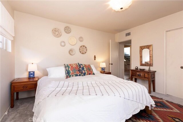 bedroom featuring carpet flooring and visible vents