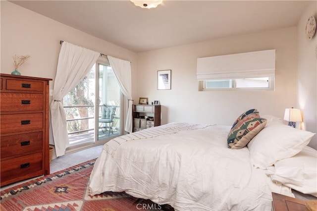 carpeted bedroom featuring access to outside