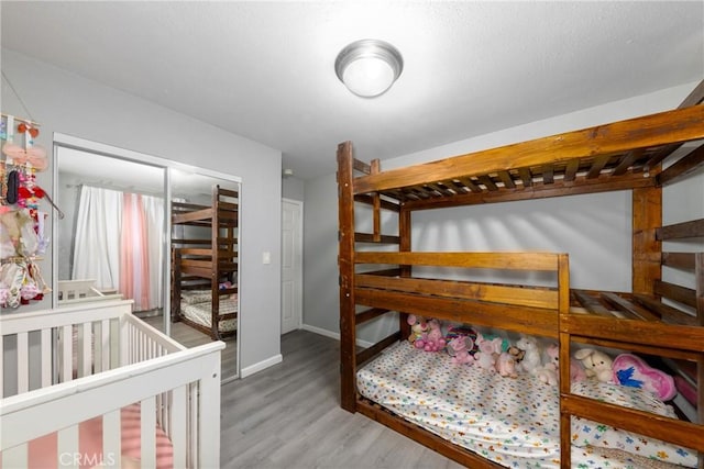 bedroom featuring baseboards and wood finished floors